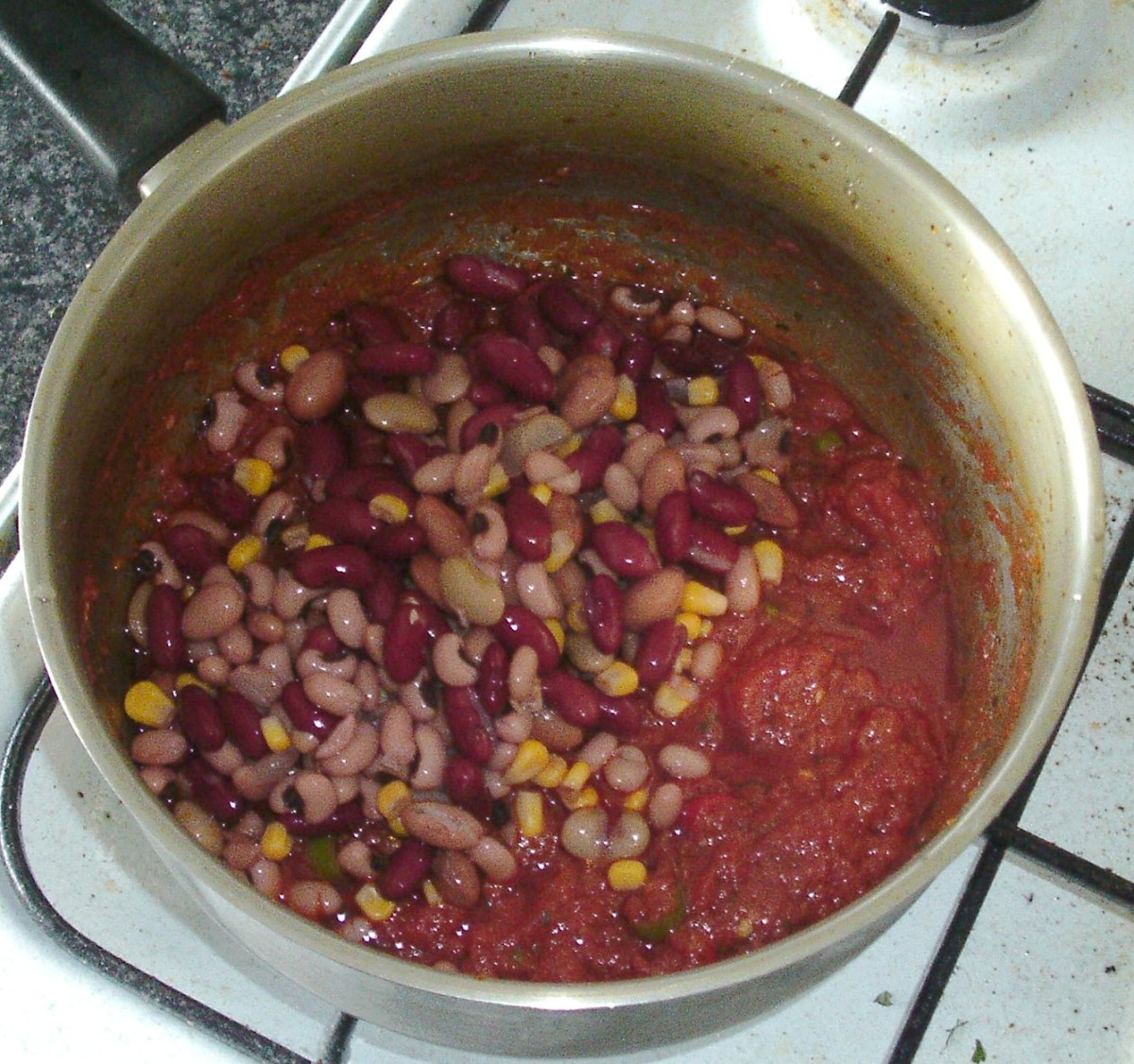 Add rinsed and drained beans to the spicy tomato sauce