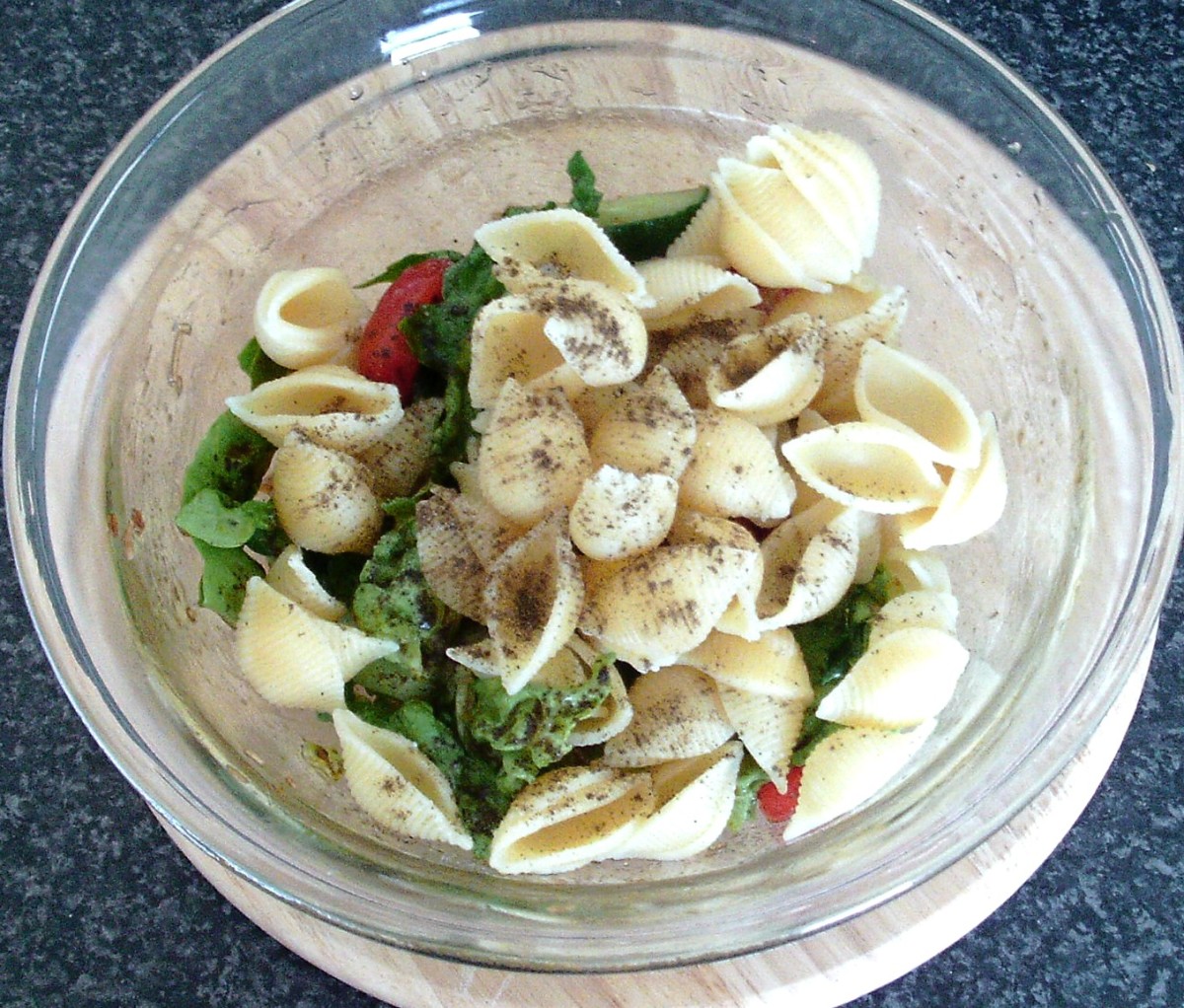 Add the cooled conchiglie pasta to the salad.