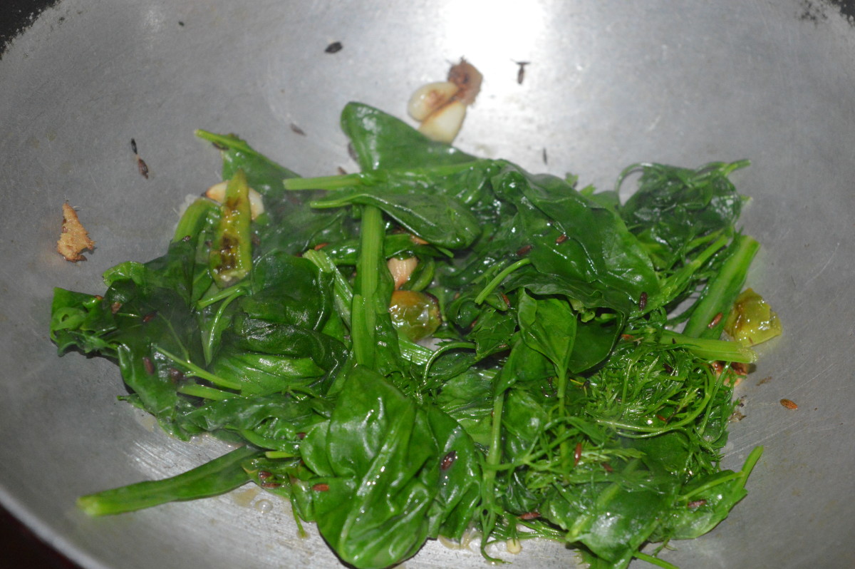 3. Add leafy greens and a very small amount of salt. (Salt helps to retain the color of the vegetable.) Saute until the greens wilt completely. Turn off the heat. Allow it to cool.