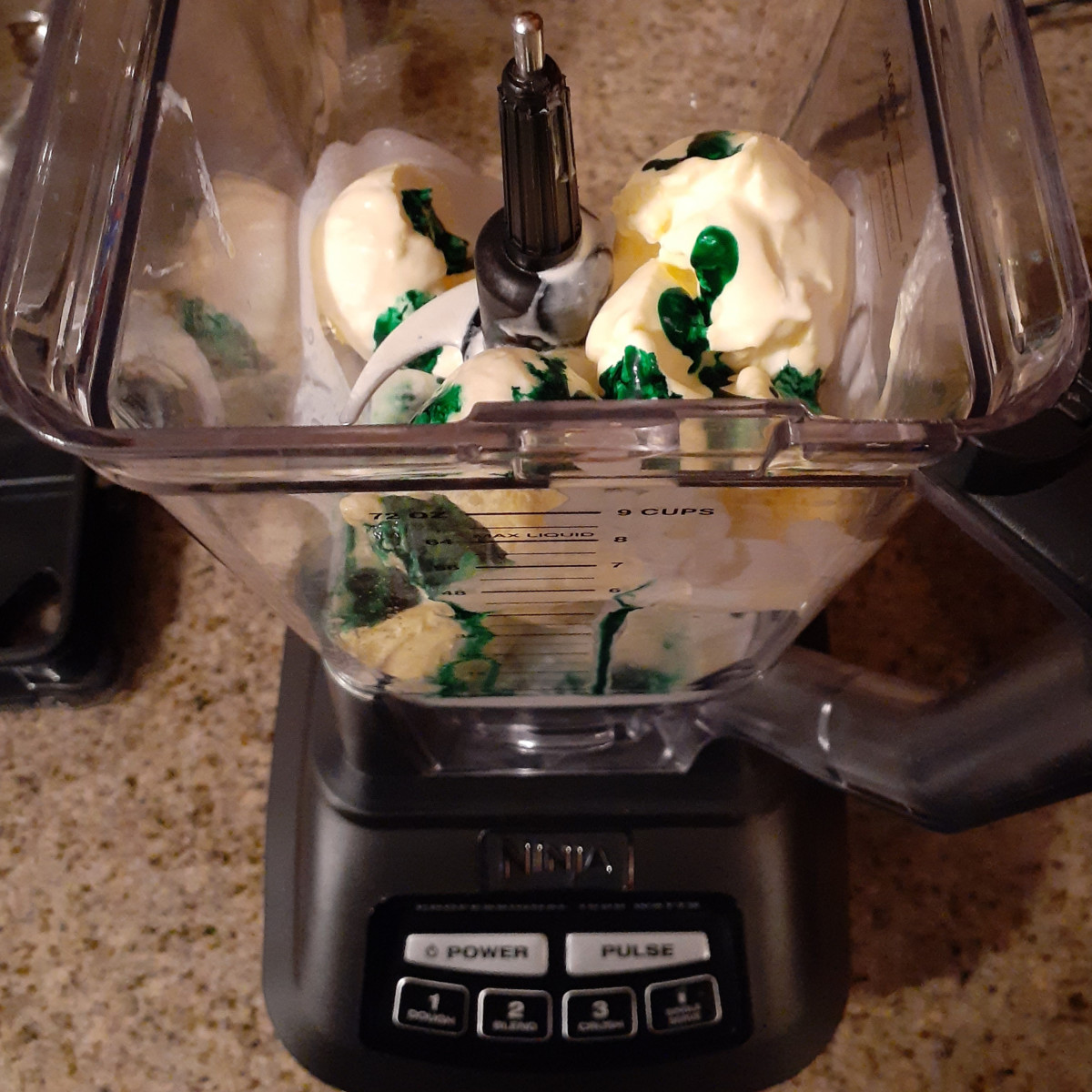 In a blender, add ice cream, heavy cream, mint extract, and green food coloring. Blend until smooth.