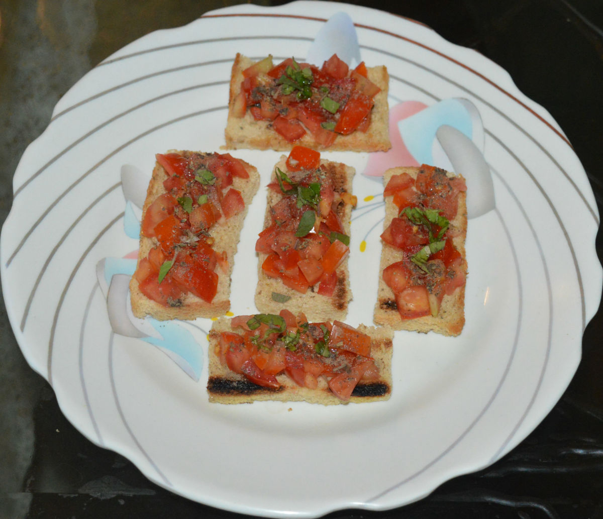 Your favorite Italian tomato basil bruschetta  is ready to serve! Serve immediately. Enjoy the crunchy,  flavorful, and delicious snack!