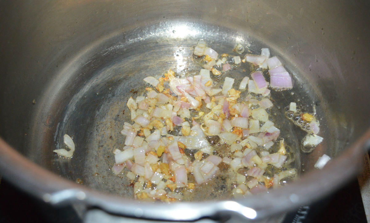 Step one: Heat oil in a pressure cooker. Add minced ginger and garlic. Saute for 1 minute. Add chopped onion. Continue sauteing until the onions become pinkish.