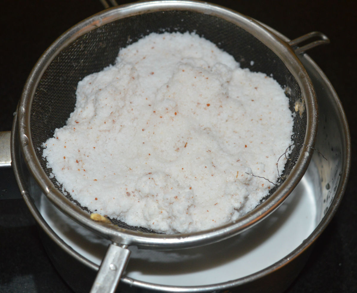Strain the mixture with a thick-layered sieve. Collect the coconut milk. Squeeze the coconut grating on the sieve to take out all the milk from it.