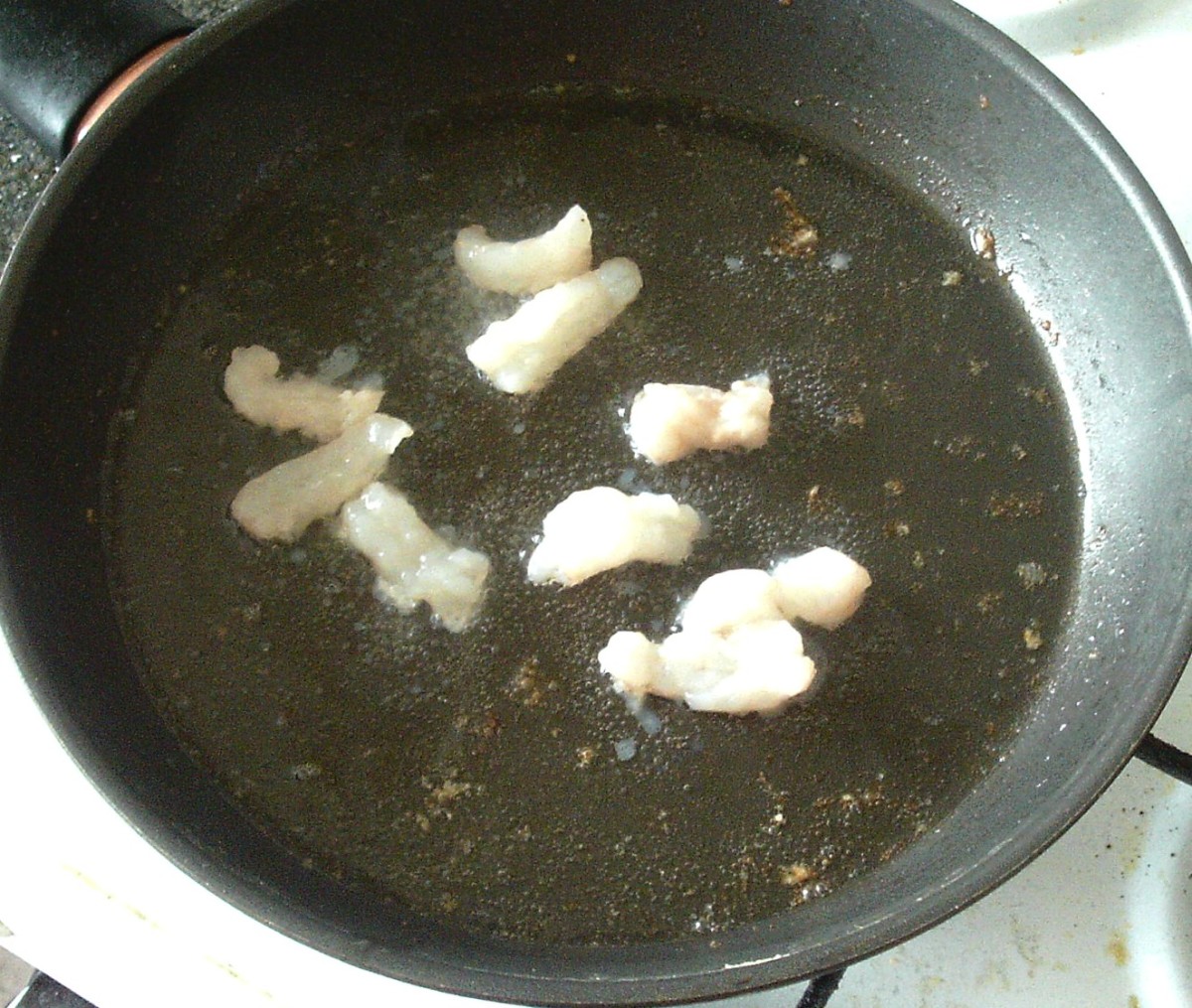 Scampi tails are quickly fried in bacon fat