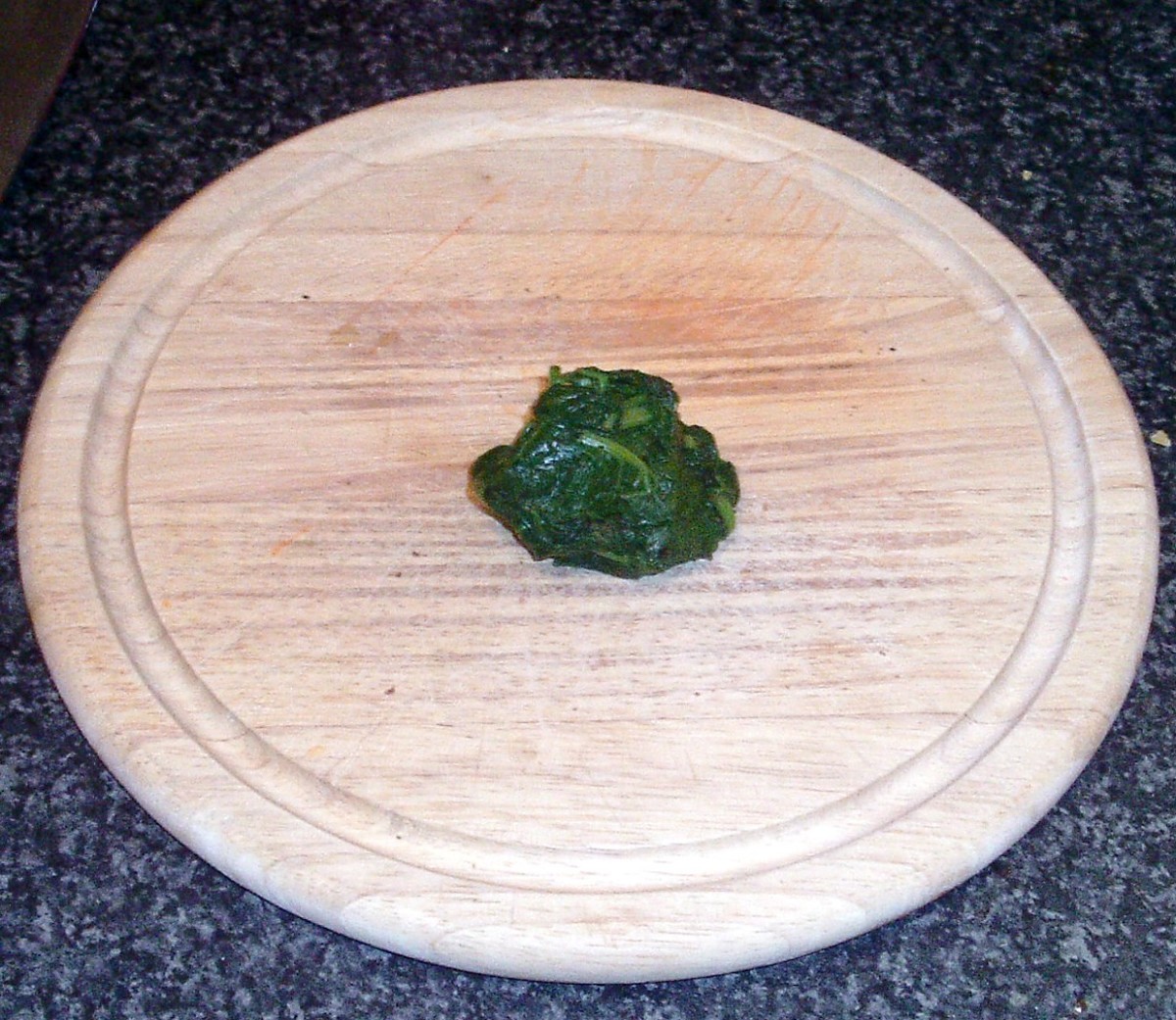 Spinach is squeezed of excess water and ready for chopping