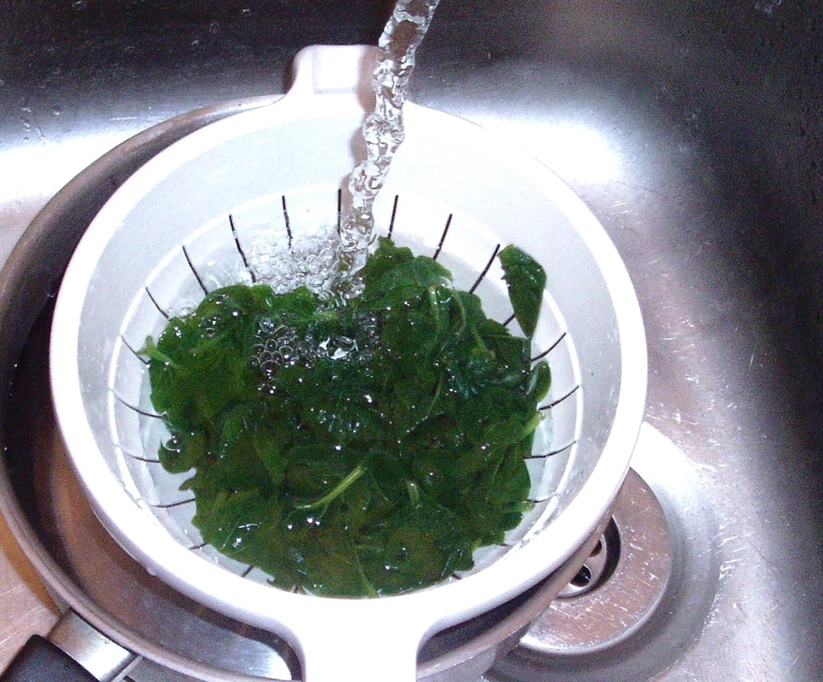 Spinach is cooled quickly under running cold water