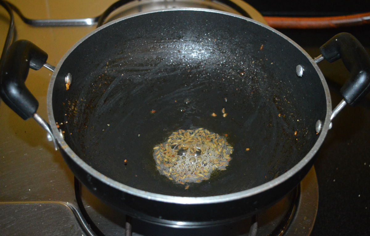Step four: Add the remaining oil to the pan. Throw in cumin seeds and allow them to crackle.