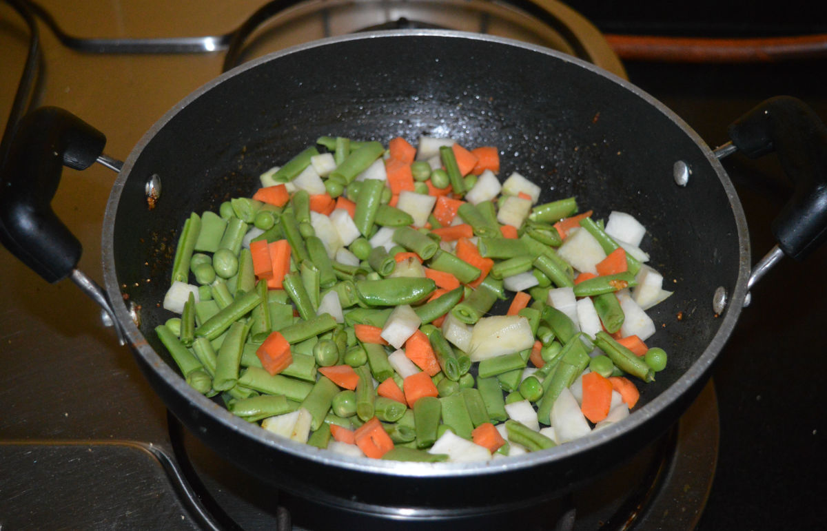 Step five: Add the mixed vegetables and some salt. Saute over medium heat for 2-3 minutes.