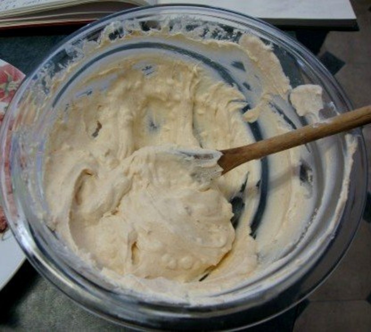 Preparing the cheese ball mixture by mixing cream cheese and mayonnaise.