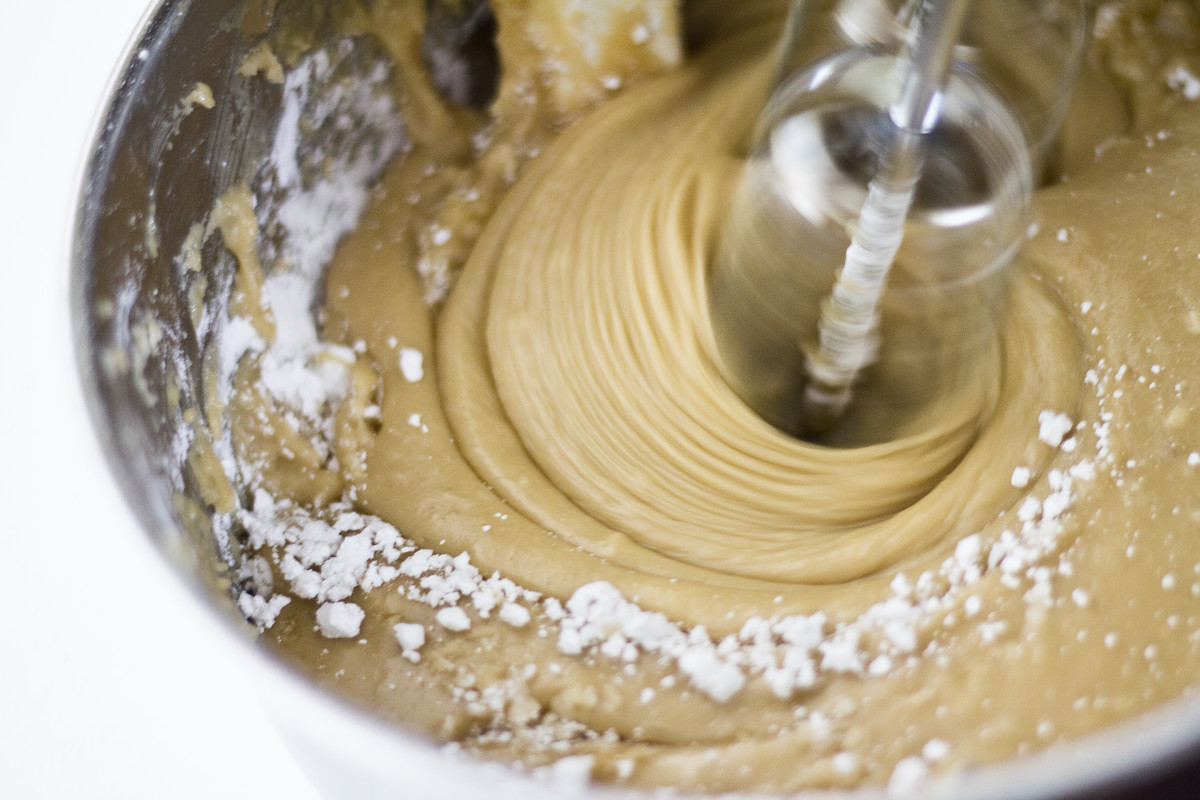 Adding the powdered sugar into your frosting mix. 