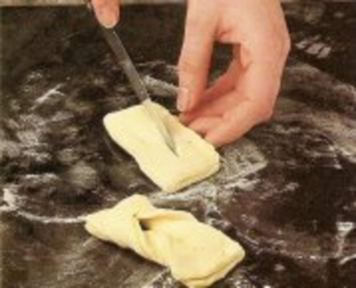 Spread dough with cinnamon butter. Make a length-wise cut.