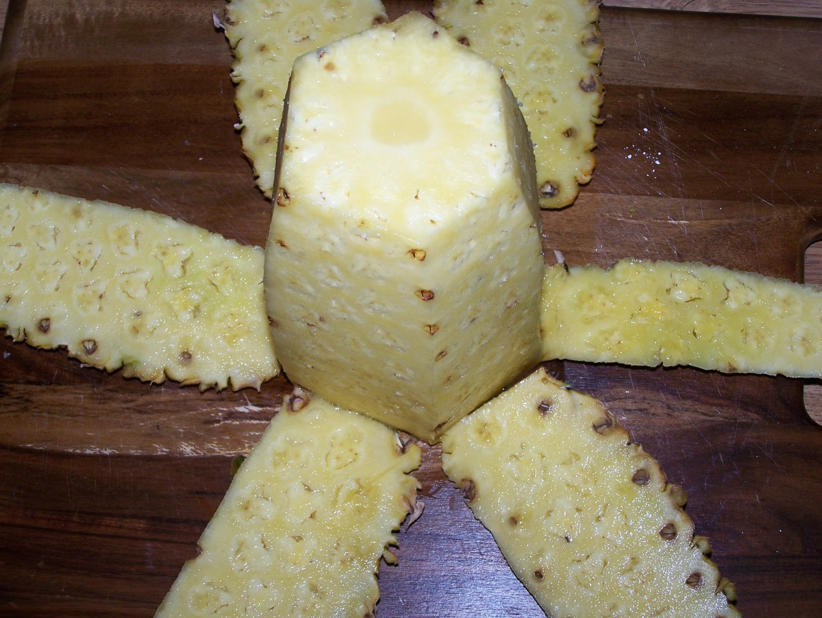 Step 6: De-skin the pineapple all the way around, until it is a soft, slimy, yellow cylinder.