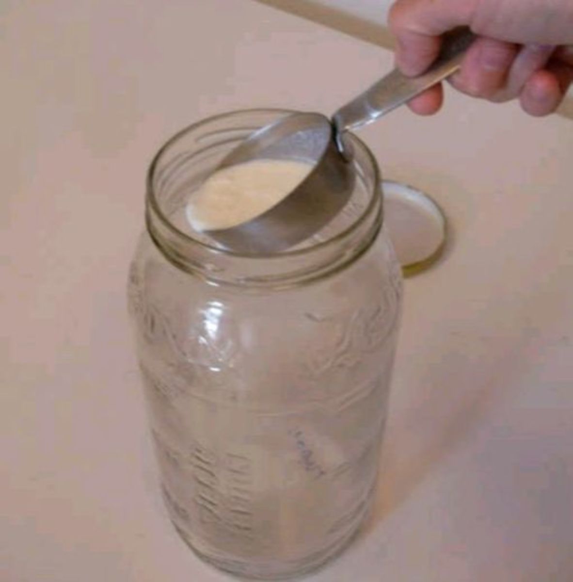 Measure about 1 tablespoon of yogurt per quart of milk, and pour into the bottom of your container.