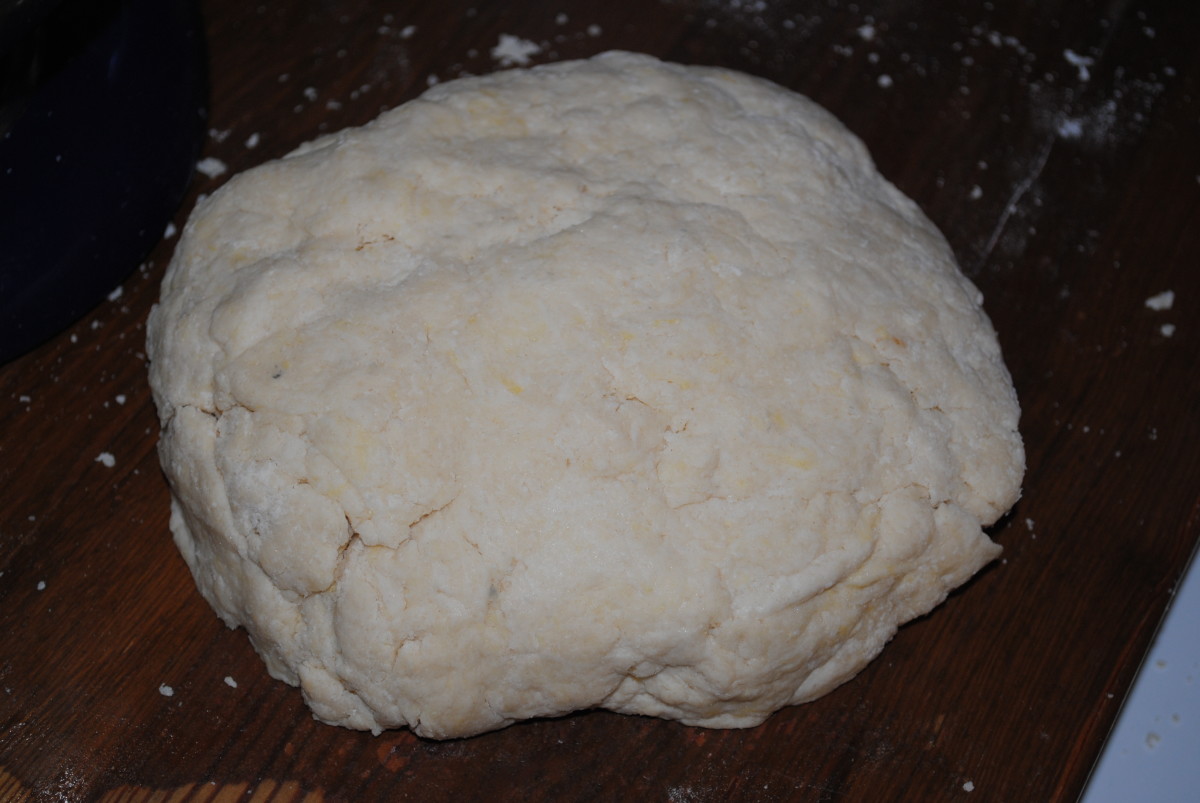 You want to knead the dough only until it will form a ball like this. Pat the ball until it's sort of flat - a disc.