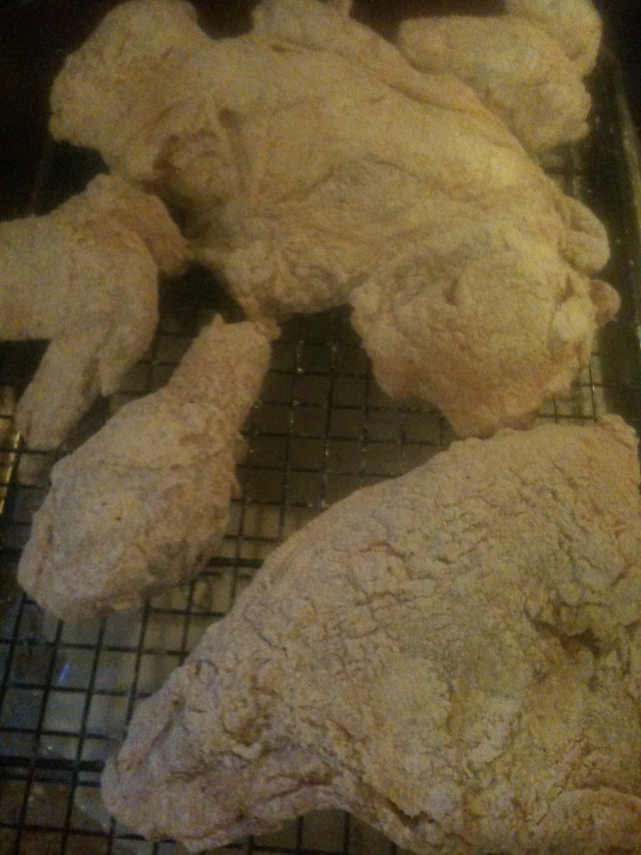 The crust will set much better if the chicken is rested on a rack for a few minutes after battering and before frying.