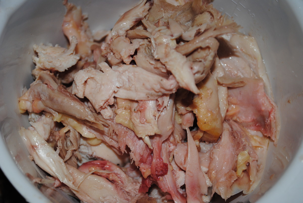 Pull all the meat from the chicken. It's ok that it's still not cooked through; you'll finish it in the soup.
