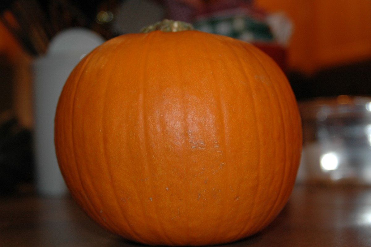 Cut the pumpkin in half and scoop out the membranes and seeds. 