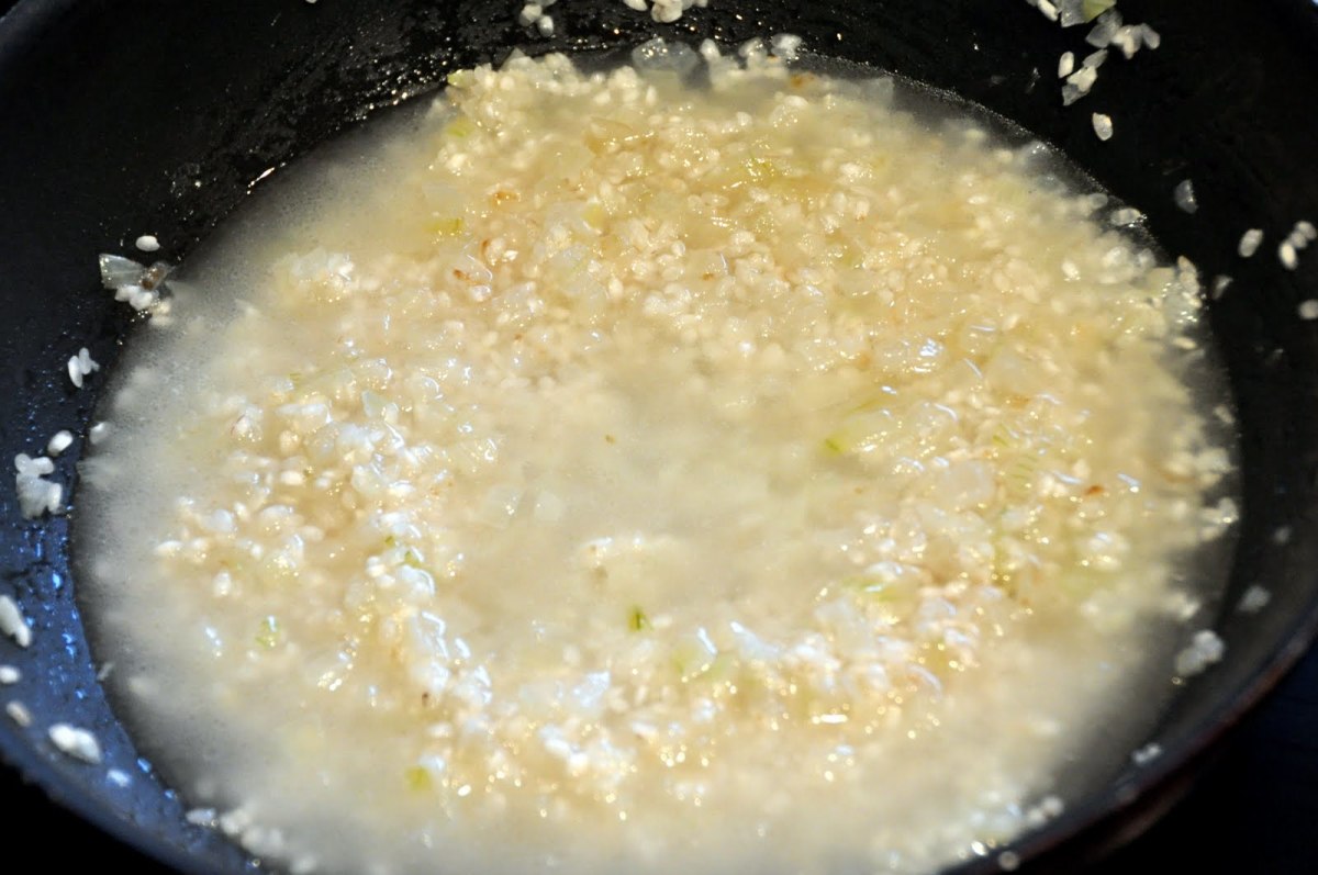 Add water over onions and rice.