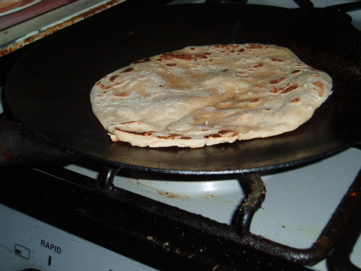Flip the chapatis over as they brown.