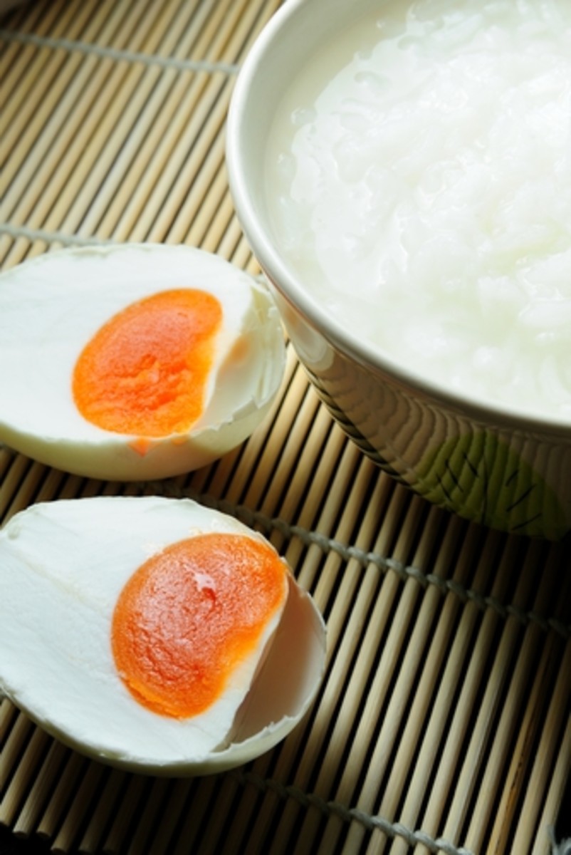 Salted Duck Eggs - delicious with congee. Notice the intensely red-gold of the yolk.  NorGal|Shutterstock.com