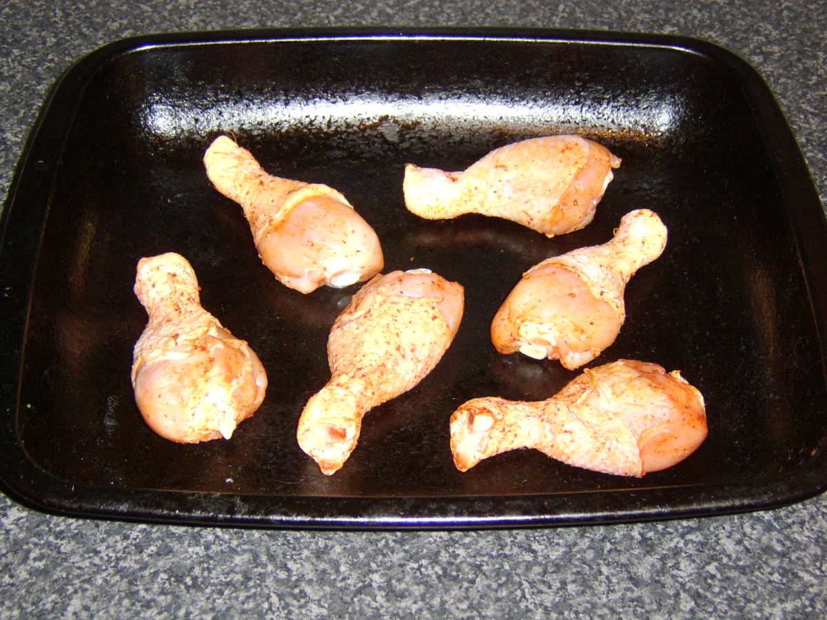 Lay the chicken drumsticks on a baking tray.