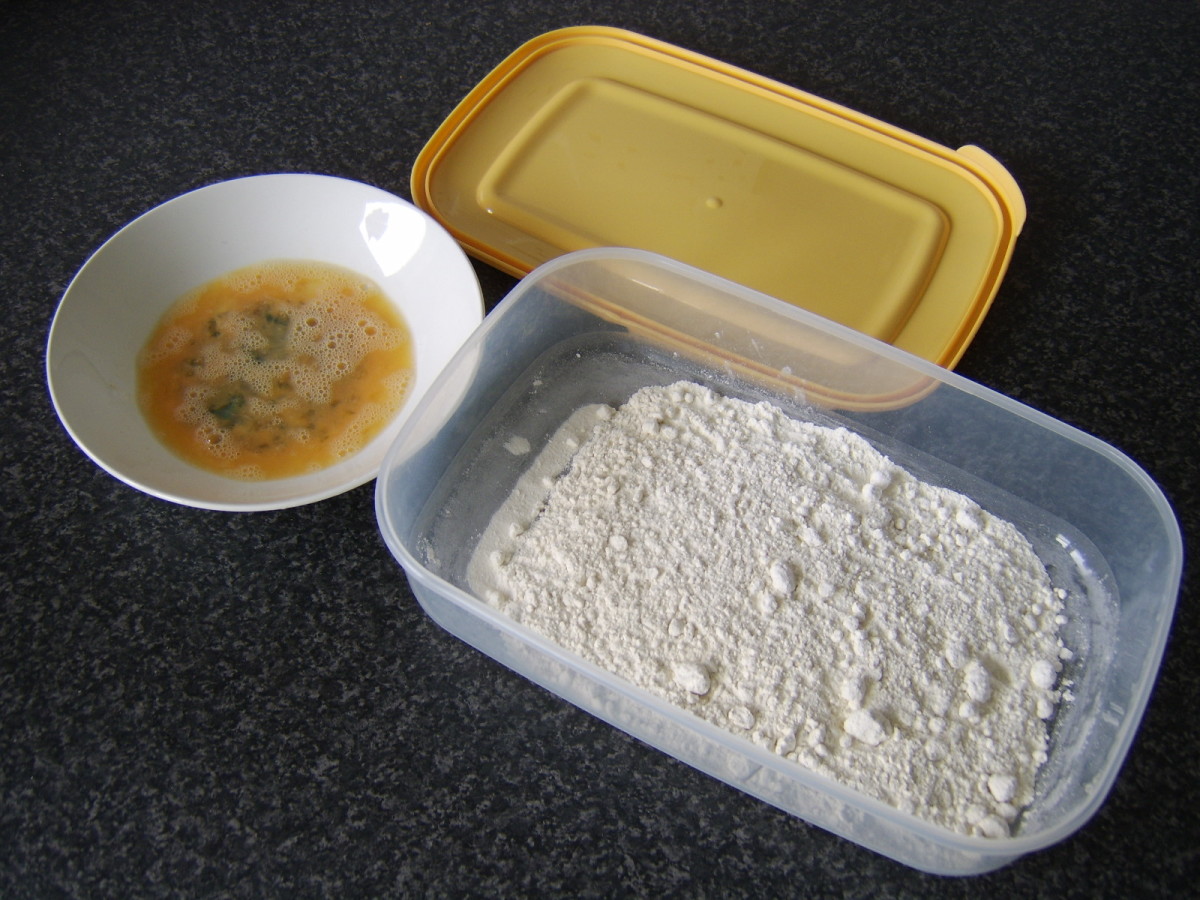 Beaten egg and flour are used to coat the chicken wings for deep frying.