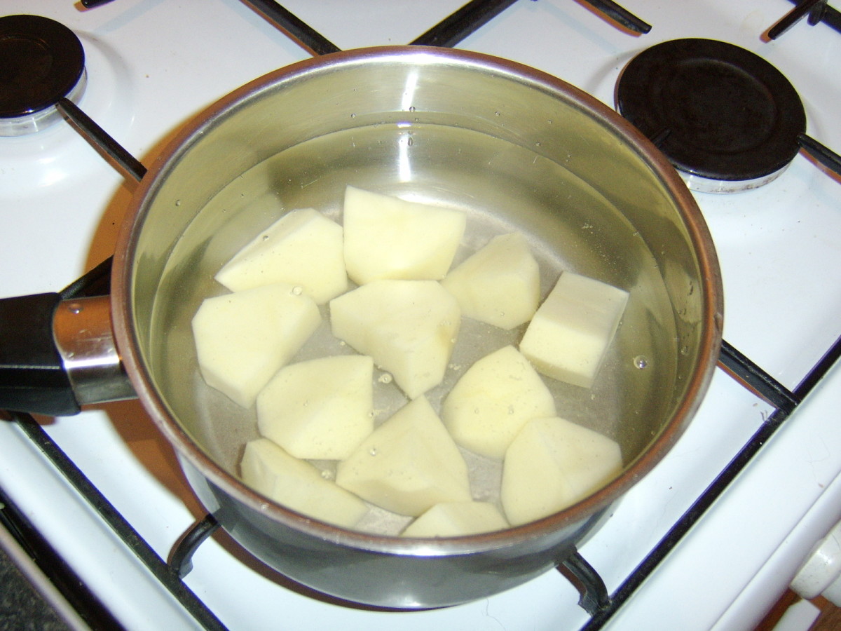 The potatoes are peeled, chopped and added to a pot of cold, slightly salted water