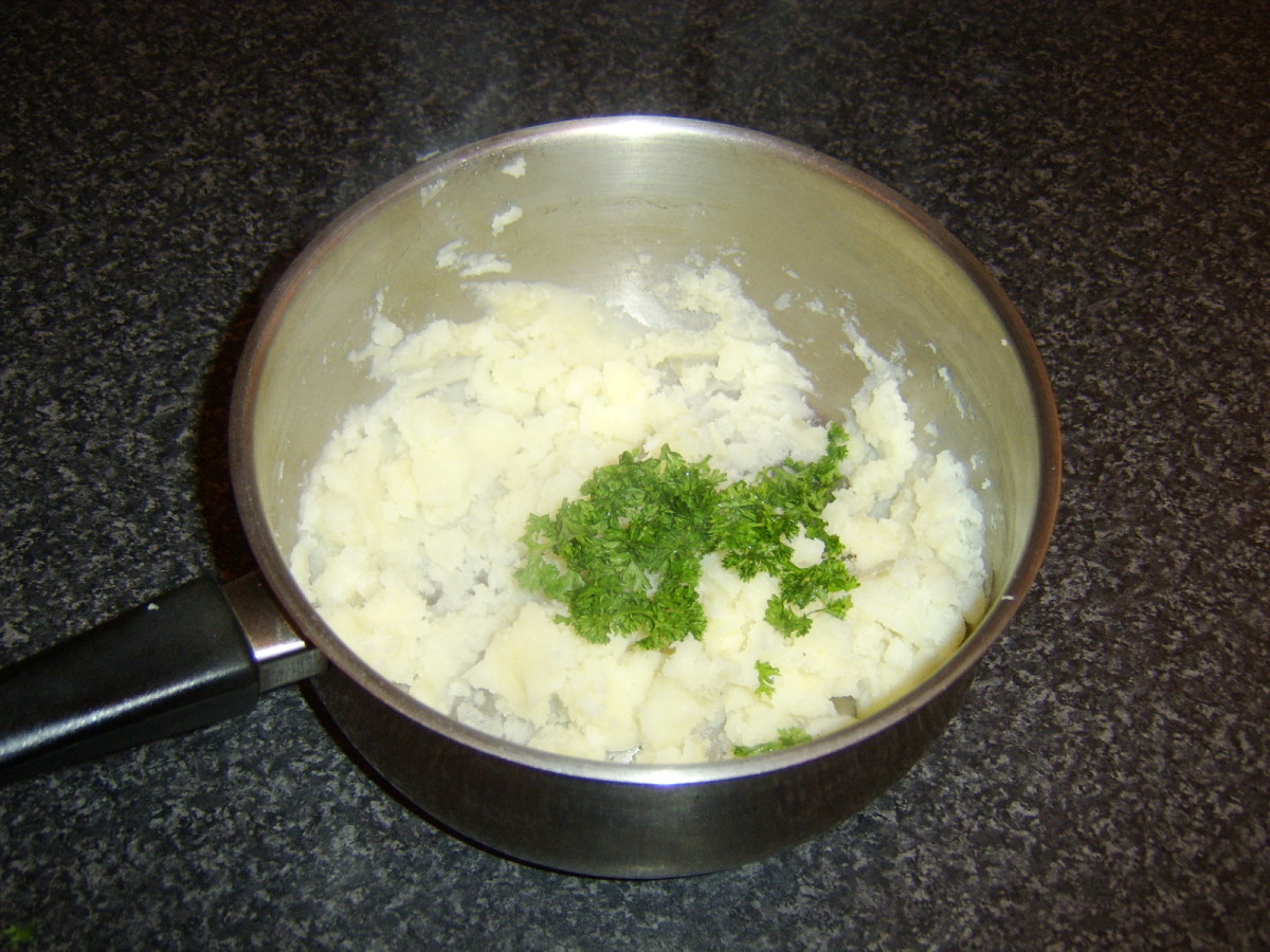 Chopped parsley is stirred in to the potatoes only after they are mashed