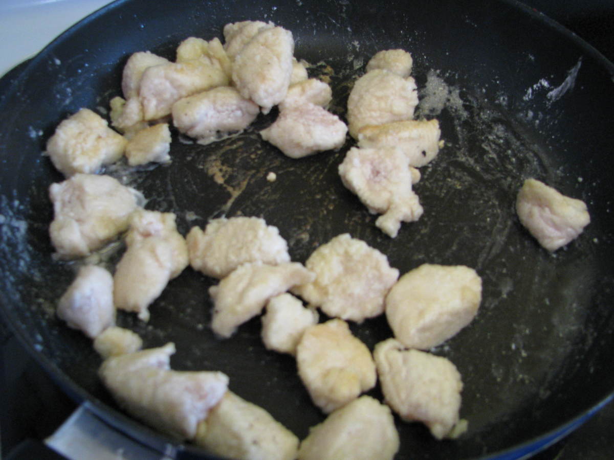 2. Stir fry the chicken. Heat up the skillet to medium. Put chicken in the pan. Sprinkle on garlic salt and ginger. Stir and fry until no longer pink inside, about 7 minutes.