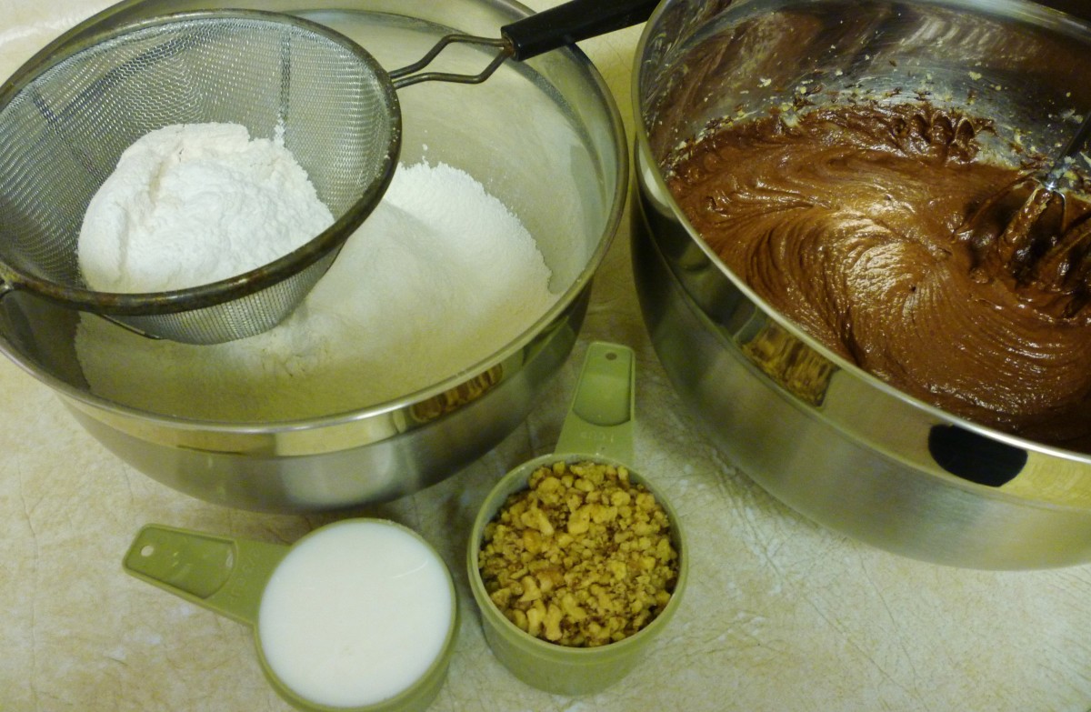 Sifted dry ingredients plus the milk and nuts readied for adding to the cookie batter.