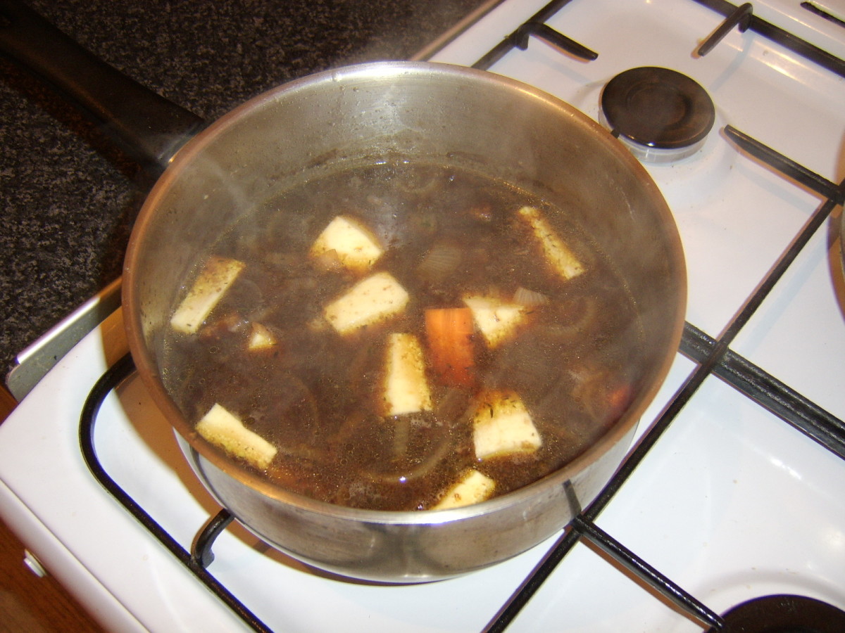 Chopped vegetables are added to the beef and ale stew for the final hour of cooking
