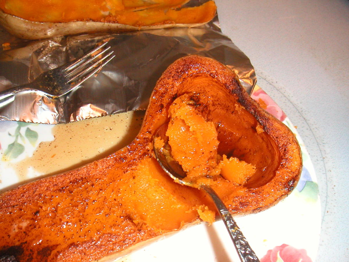 Scooping out the cooked squash