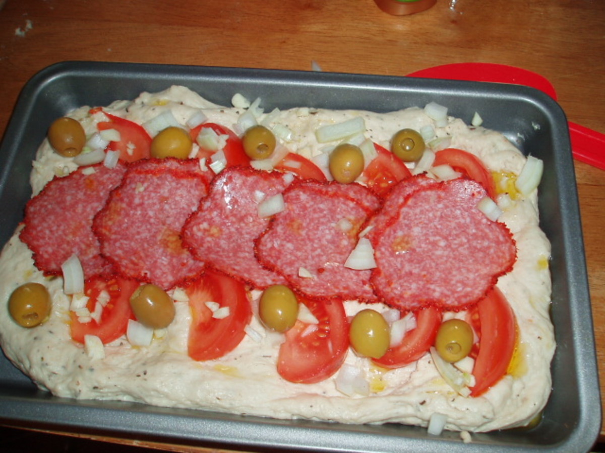 slices of ham with olives and a cheese topping