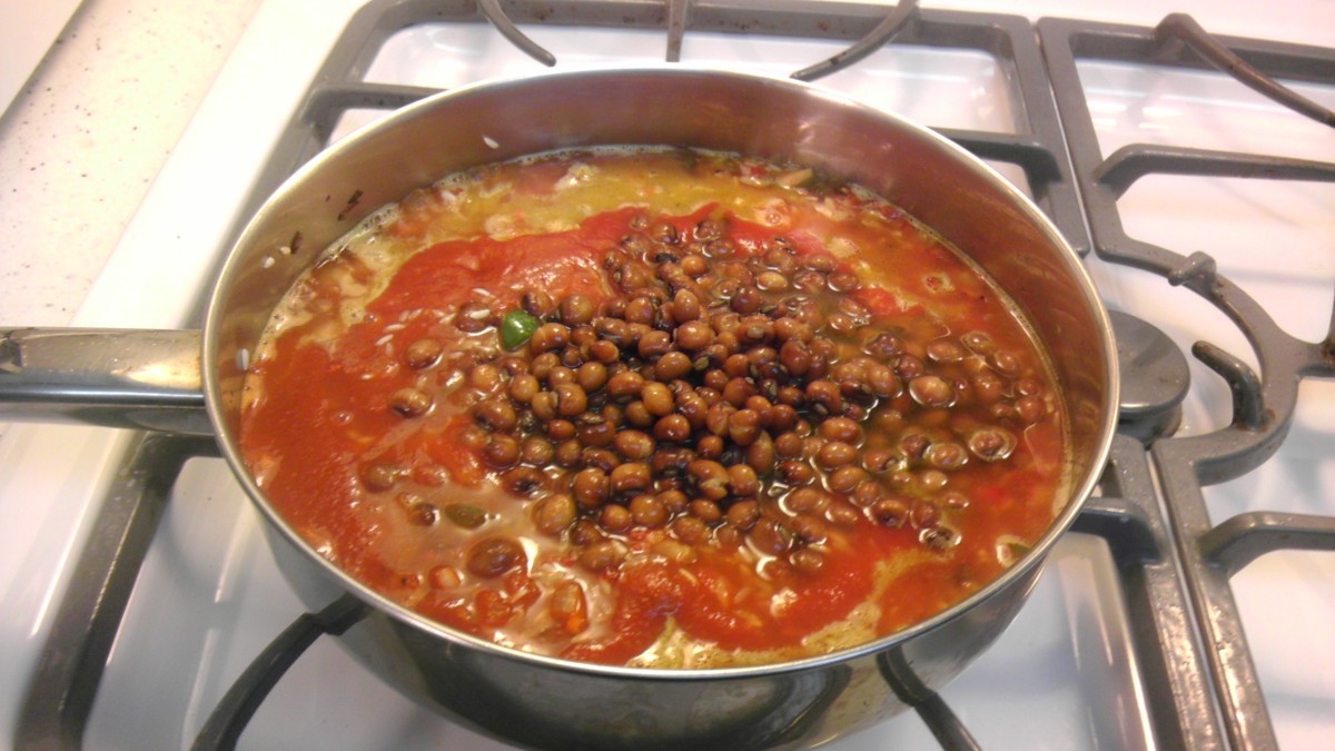 Add the liquid ingredients, gandules, and olives.
