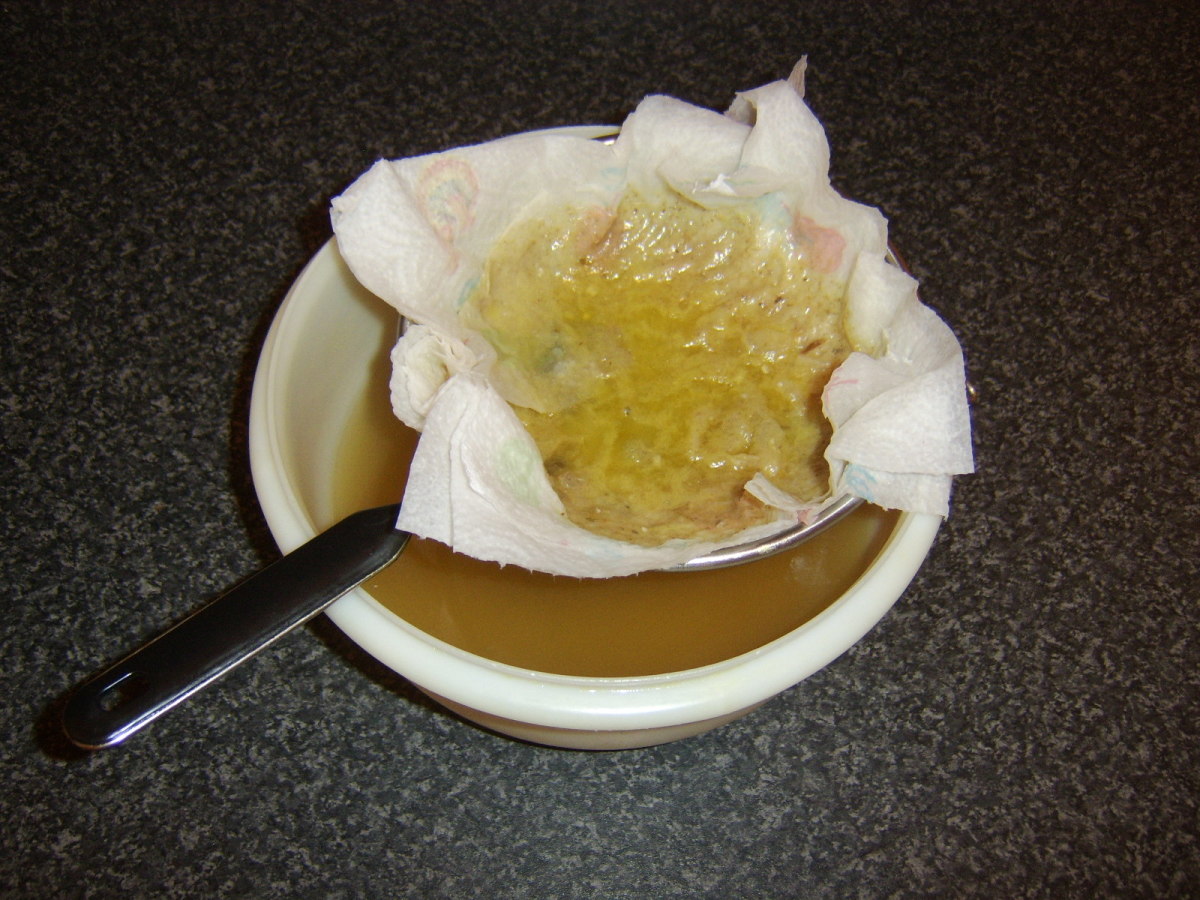 The fat from the lamb stock can be seen to be trapped in the kitchen paper.