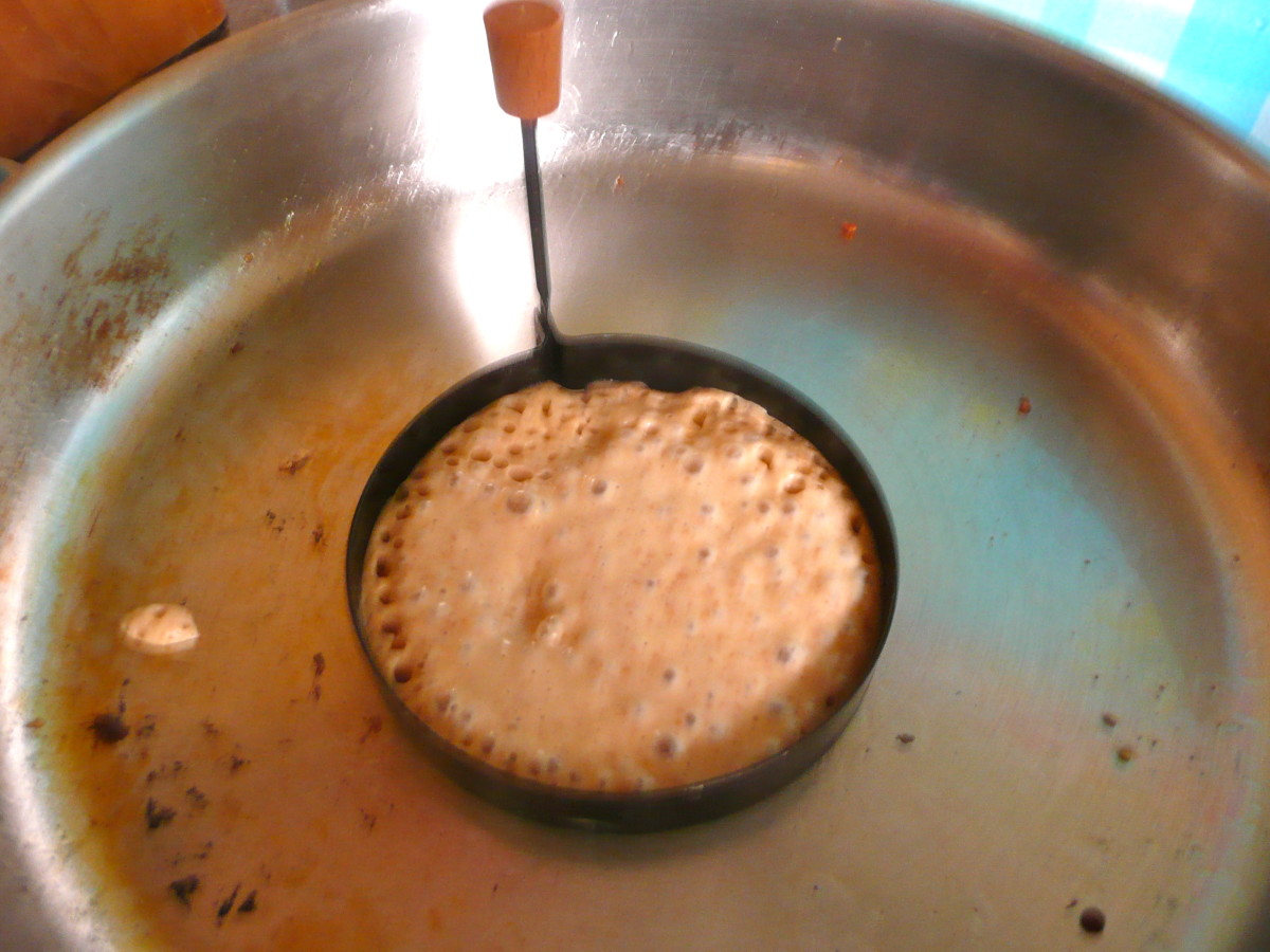 Pour the batter into the egg ring. When bubbles form on top, the pancake is ready to turn.