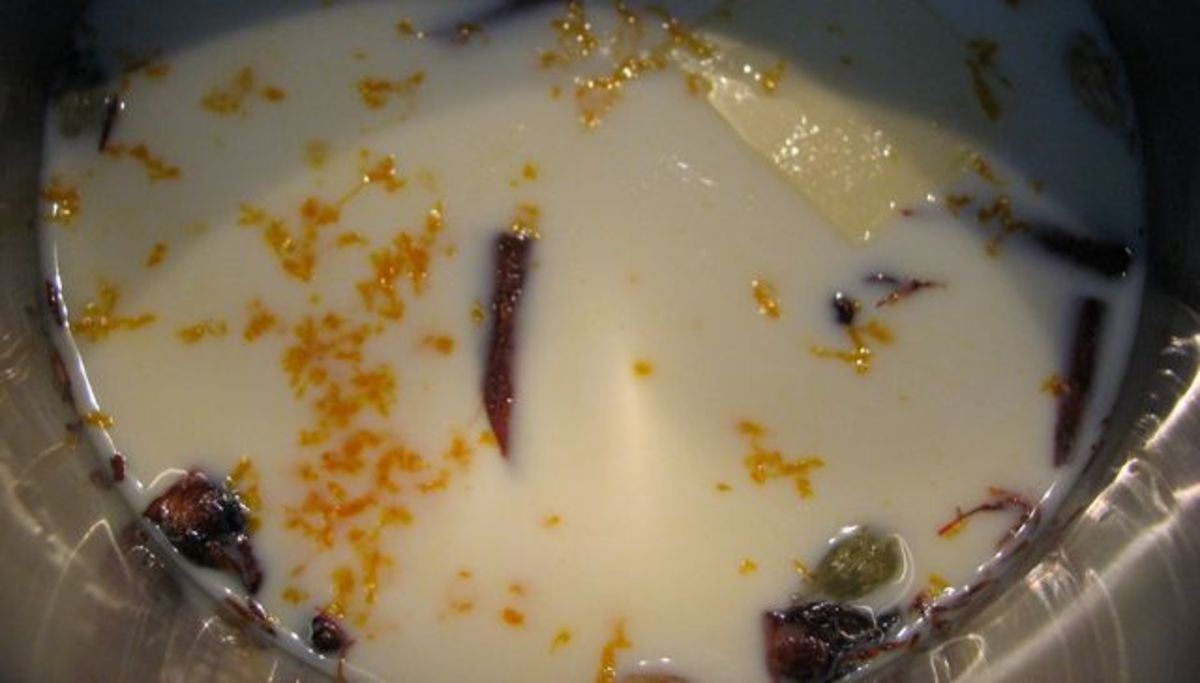 Infuse the milk with spices, orange rind, and a little butter.