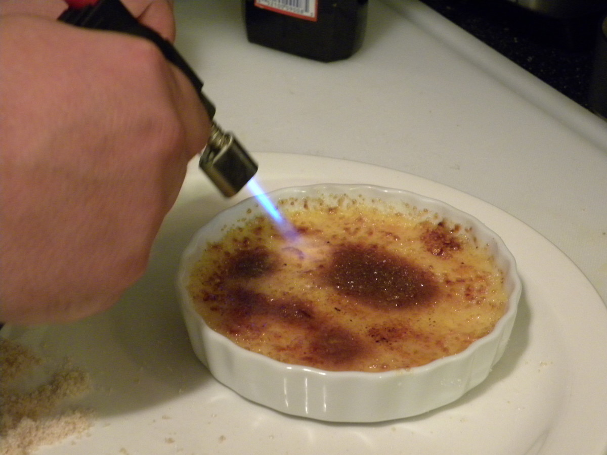 Using the torch to caramelize the sugar coating.
