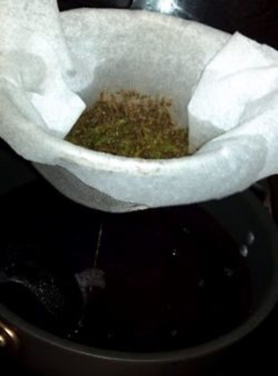 Strain the herb brew into a saucepan.