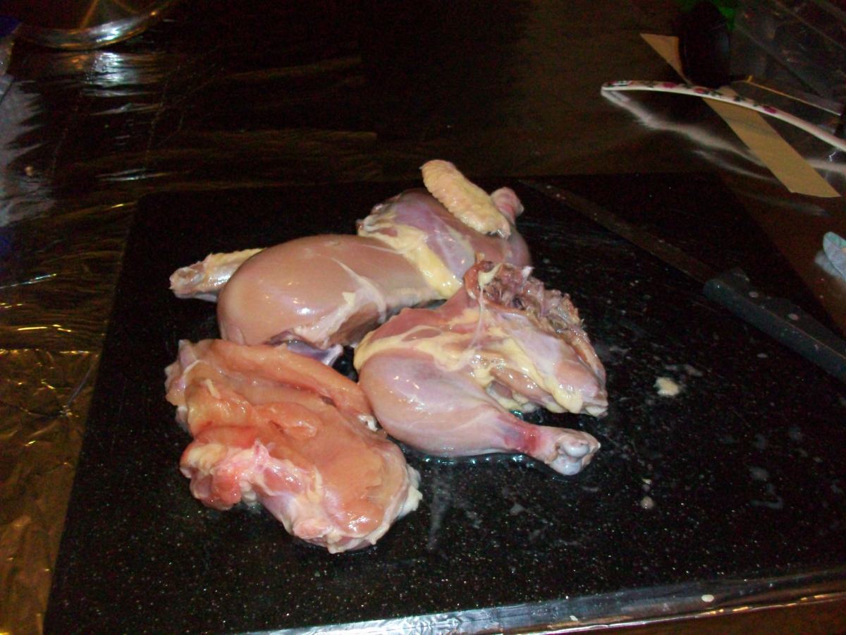 Naked chicken, ready for soup. This is what my chicken looked like after I wrestled him into submission. It's a lot easier to start with chicken parts than to try to cut it apart yourself to make it fit into the pot.
