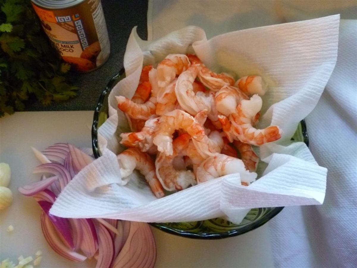 If you are using raw, uncooked shrimp, now is the time to add them and cook until they're pink.