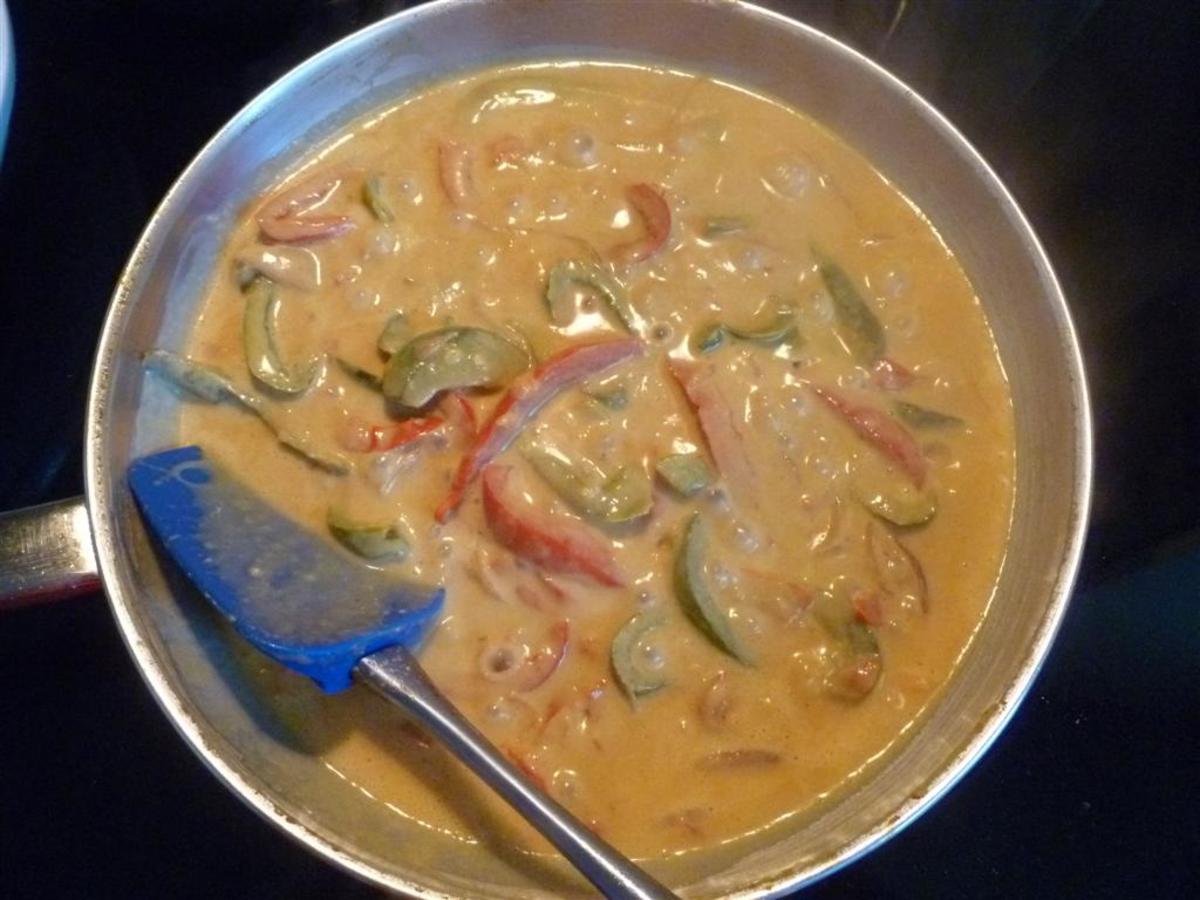 Add the strips of red and green pepper and toss for about 10 minutes or until they soften a bit. Add the can of coconut milk, stirring to blend all of the ingredients, and simmer for about 10 minutes.