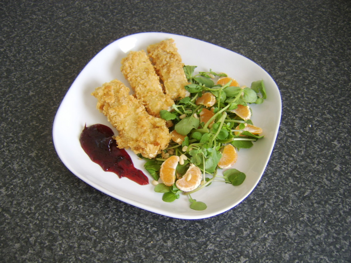 Breaded Camembert, watercress, satsuma and pine nut salad and port and cranberry sauce is ready to serve