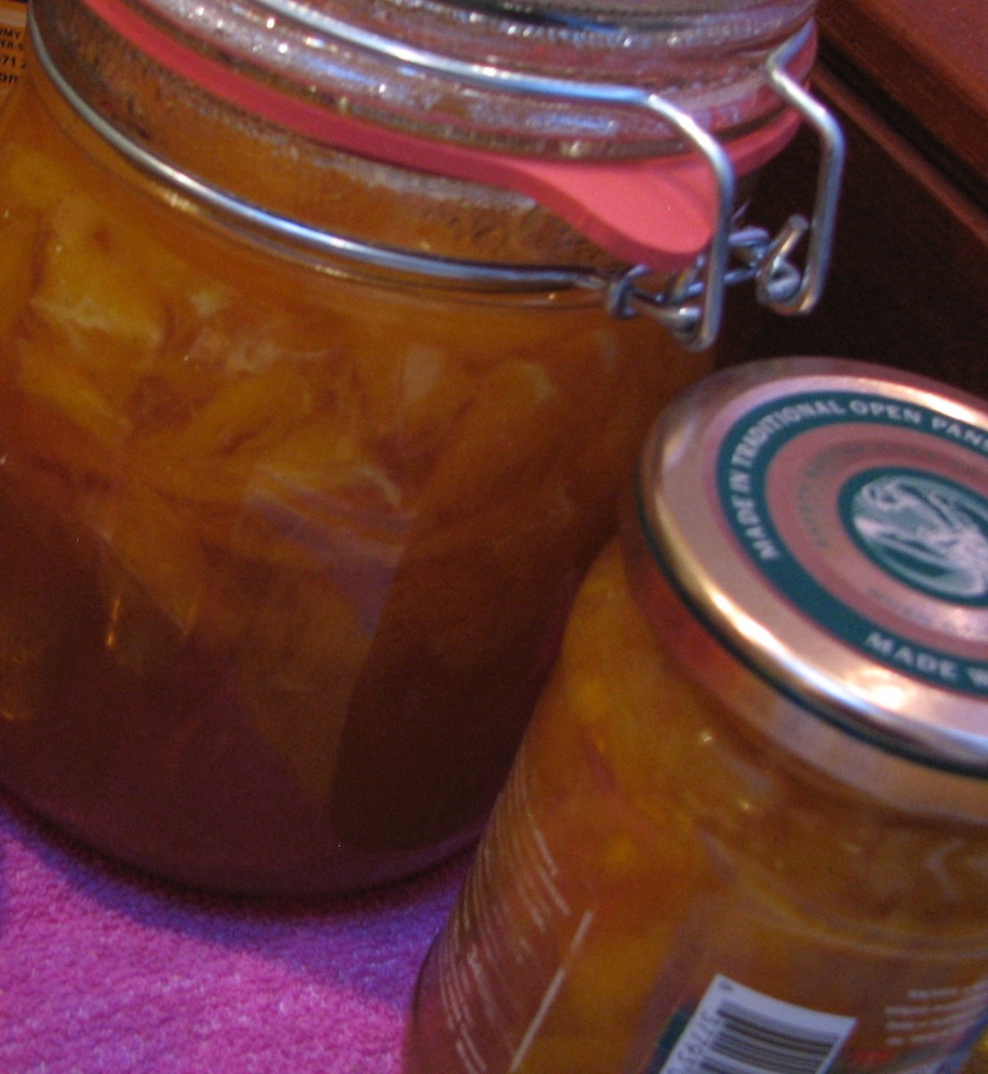 Bottled orange vanilla compote in glass jars. The compote has a lot more liquid than the marmalade.