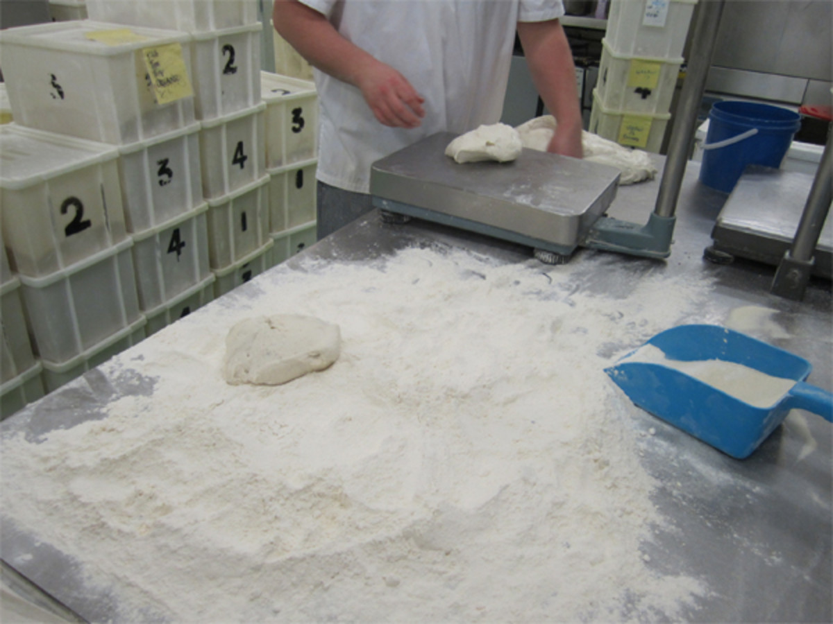 Dough portions are individually weighed for consistency of loaf weight. 