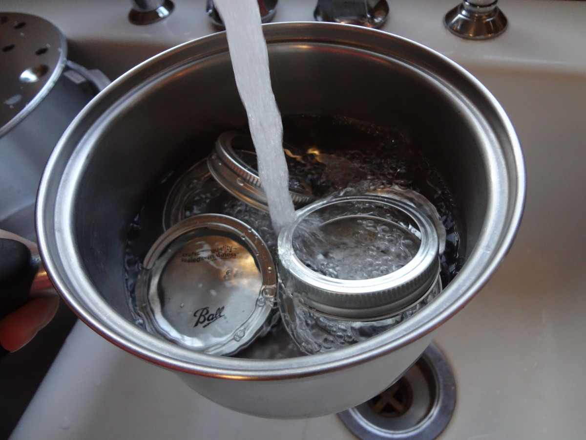 Sanitize the lids and bands by boiling them in water.