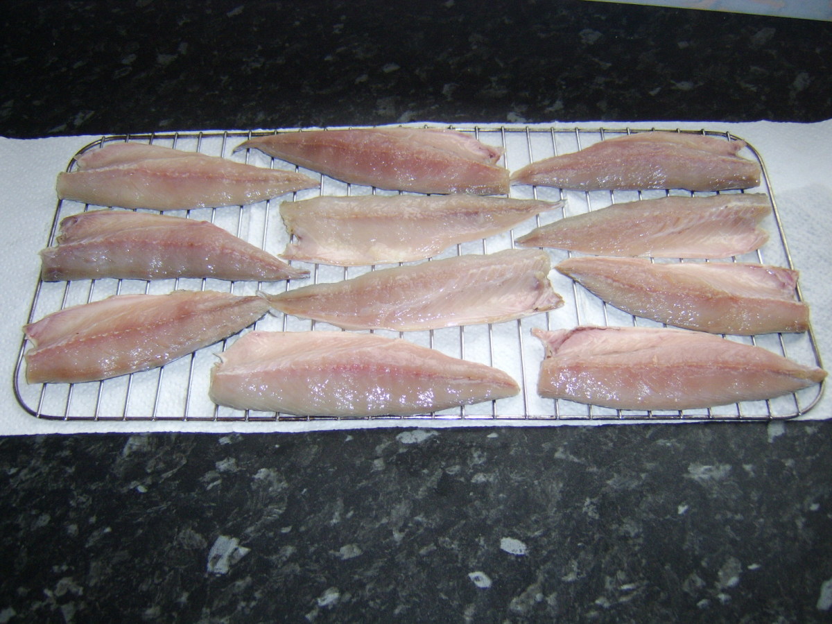 Mackerel fillets are laid carefully on rack for smoking
