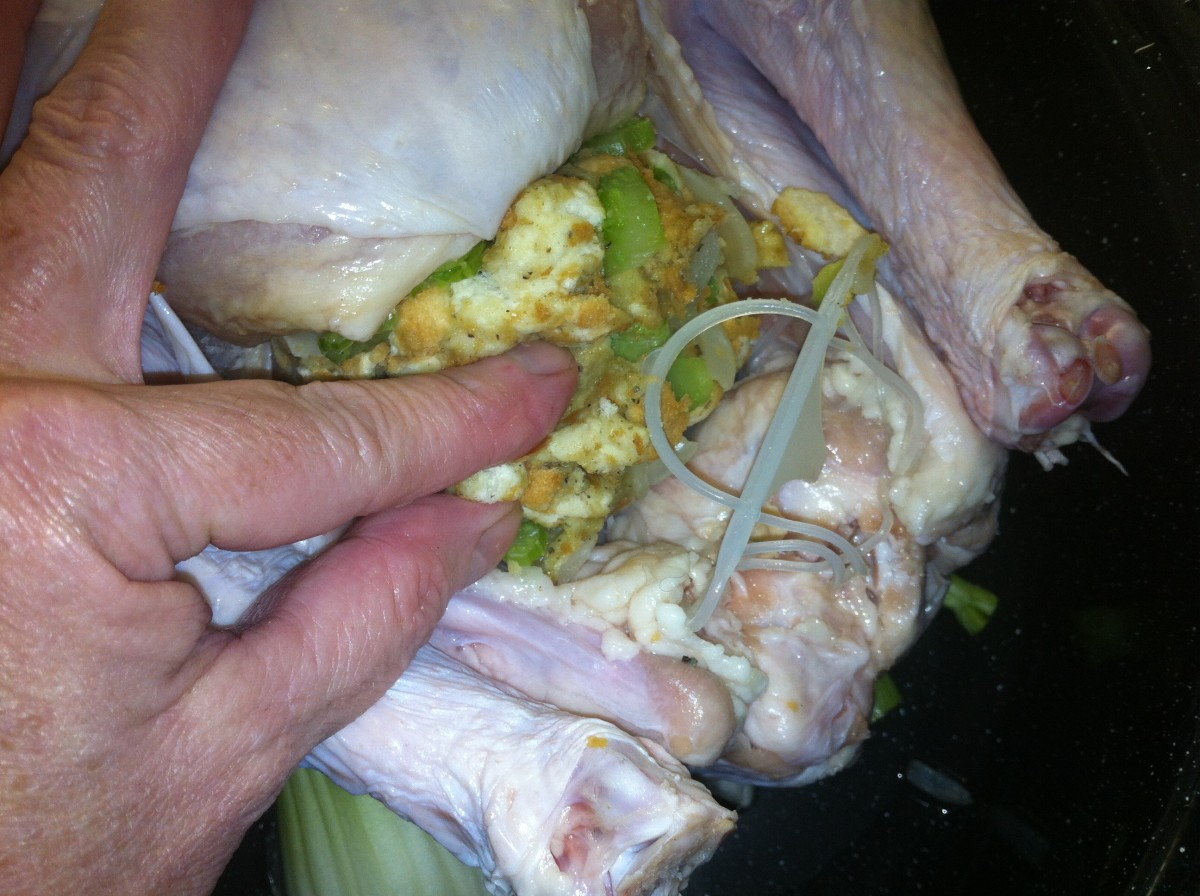 Insert the stuffing into the turkey.