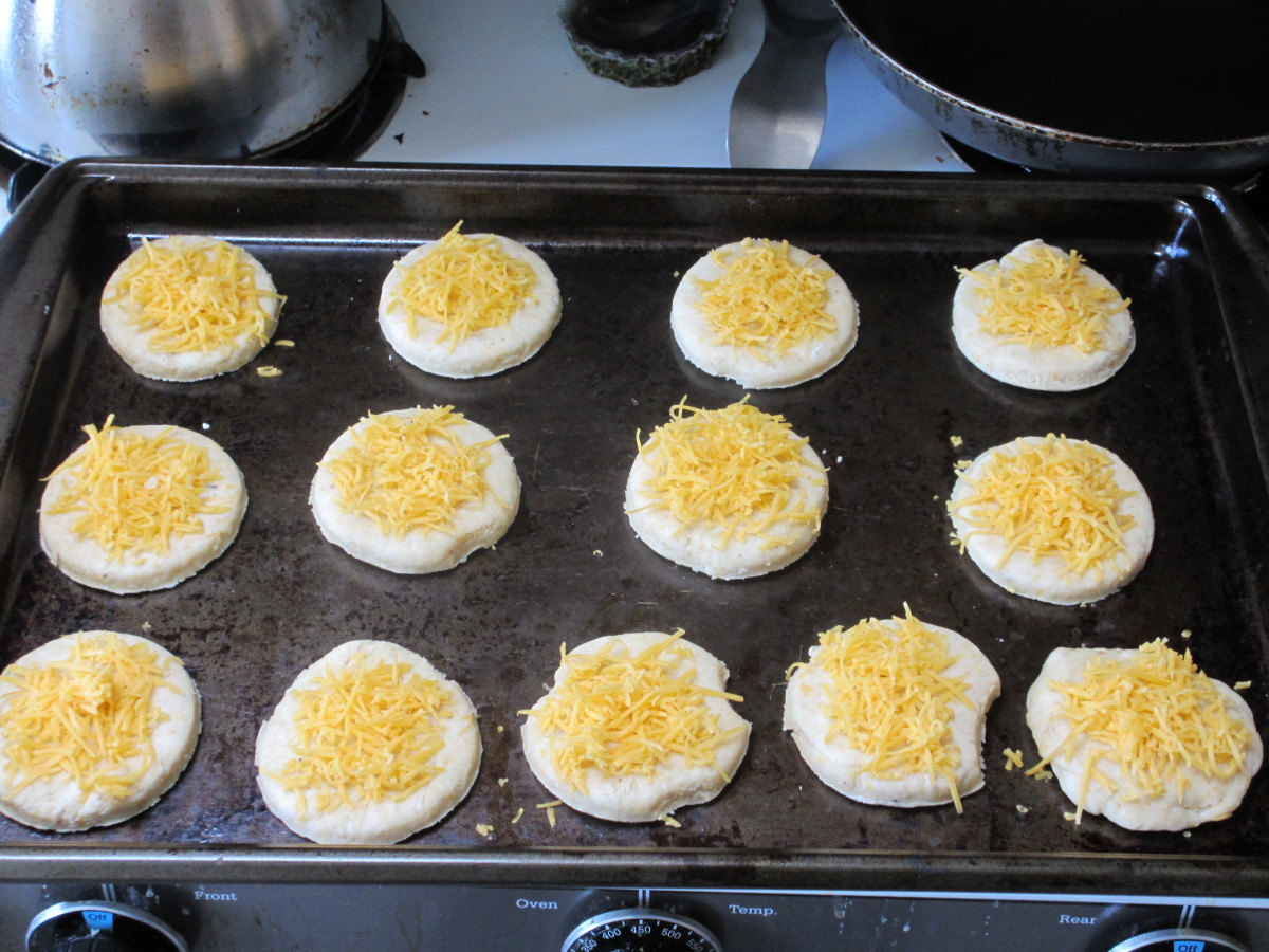 Sprinkle the tops of the biscuits with the remaining cheese and bake.