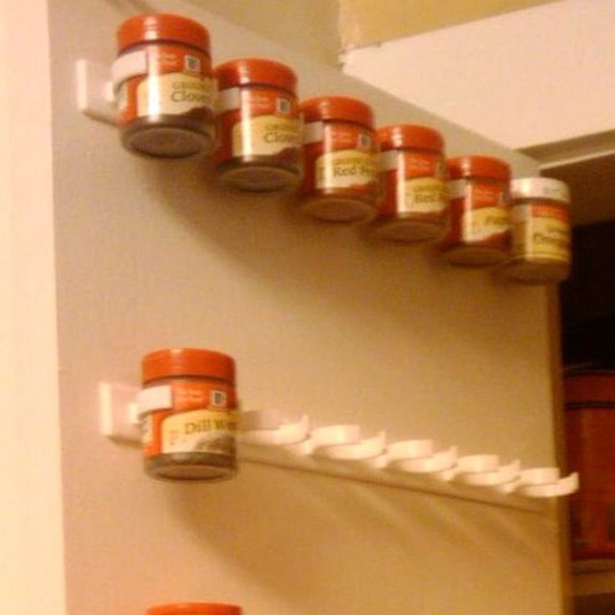 Mop holders mounted on the inside of a cupboard door